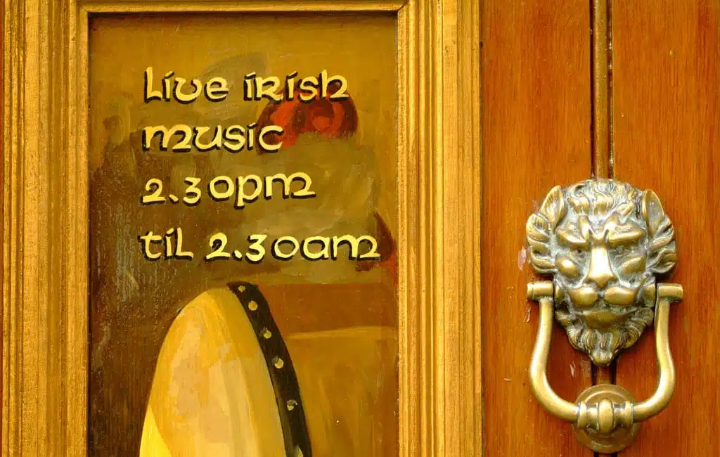 Close up of Dublin pub door with lion doorknob and live music sign